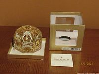 Ornament displayed in front of original box and Baldwin instruction pamphlet