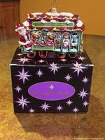 Ornament displayed on top of original decorative box with Christopher Radko logo.