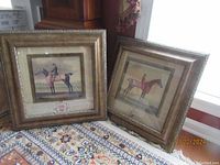 Photo of two framed equestrian prints by Sartorius on patterned carpet.