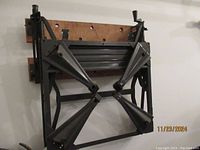 Black metal work bench folded showing its sturdy frame and legs.