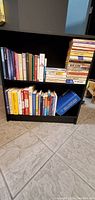 Bookshelf with various books arranged including self help and health topics.