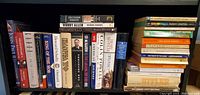 Photo of books on a bookshelf including titles such as Decision Points by George W. Bush, Woody Allen by Richard Schickel, and others.