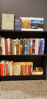 Wide shot of shelf with multiple books focusing on Canadian military history and war.