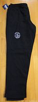 Front side view of black track pants showing Sons of Anarchy patch embroidered on left leg.