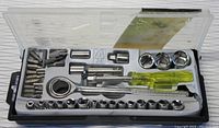 Socket set inside plastic storage case showing ratchet wrench, sockets, bits and screwdriver handle