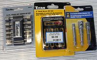 Front view of packaged Tekrite 14-piece driver set, Titan 2-inch deck screw bit set in yellow package, and socket driver adapter set