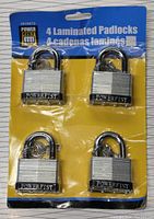 Four laminated steel padlocks by Powerfist displayed in original packaging.