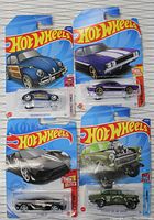 Package of four Hot Wheels die-cast cars unopened and displayed in blister packs, showing VW Beetle, 69 Charger, 17 Ford GT, and 55 Chevy Bel Air
