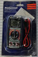 Mastercraft Digital Multimeter still in original blister packaging showing front view with dial, leads, and LCD screen.