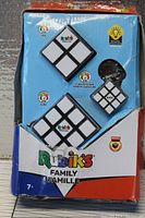 Front of box showing the images of the three included Rubik's Cubes: the classic 3x3, Mini Cube, and Cube keychain