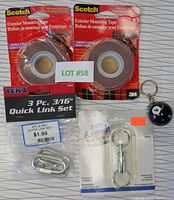 Photo shows all items including two packages Scotch exterior mounting tape, 3 piece quick link set, key ring packaging, and 8 ball key ring.