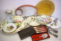 Full overview of lot items showing plates, pitcher, cutlery, and serving utensils arranged together