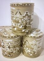 Three round vintage Disney tins featuring black-and-white classic Disney character art with sepia tones, displayed stacked.