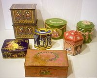 Full lot display showing all eight vintage tins arranged on white background. Various shapes and rich floral designs visible.