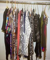 Wide view of dresses and cardigans hanging on a rack showing a mix of patterns including animal prints and bold designs