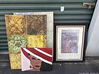 Photo showing four pieces of art: one framed glass print labeled Joy Smith, and three canvas artworks with various designs.