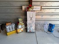 Full lot including boxed crystal rotary slide show lamp, boxed Mikasa angel candleholders, Godinger mantle clock, angel figurine, sculpted candle pillars, and other crystal items.