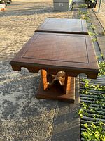 Full top and side view of two matching wooden end tables with scalloped edges and square tops, showing surface and wood grain details.