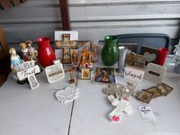 Full assortment well displayed on table showing all items together including figurines, crosses, word plaques, and vases.