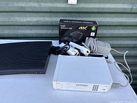 Lot contents showing ProHT Android TV Box in box, Nintendo console, Samsung DVD player and accessories