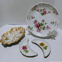 Front view of all four porcelain pieces showing designs and colours