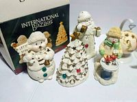Close-up of five International Bazaar ceramic figures and box