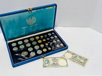 Open Royal Thai Mint case showing full array of coins and two banknotes