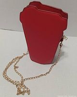Side/top view highlighting purse shape and zip closure with chain strap
