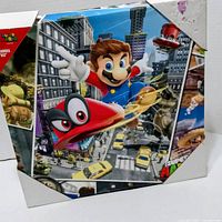 Front view showing Mario and Cappy artwork on canvas with corner protectors