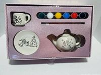Box interior showing teapot, cup, saucer, six paint pots and brush in molded tray