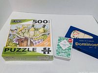 Front view of sealed Lang puzzle, sealed conversation cards deck, sealed dominoes set