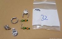 Group of six sterling silver jewelry pieces on background