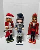 Front view of three wooden nutcracker figurines