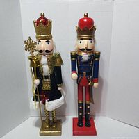 Front view of both nutcracker figures showing crowns, uniforms, bases