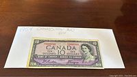 Front side of the 1954 Canadian $10 bill showing Queen Elizabeth II portrait and serial numbers.