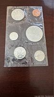 Set of six 1963 Canadian coins sealed in original plastic packaging, showing both obverse and reverse, including Queen Elizabeth II portrait and Canadian symbols