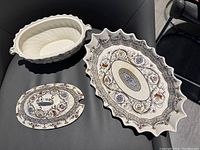 Covered vegetable dish with matching colorful pattern and two small handles, lid with handle shown separately