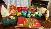 Photo showing all items in the lot arranged on a table including goose figurines, mugs, ornaments, and Christmas cards.