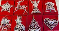 Front view of the 8 Lenox ornaments displayed on their red boxes showing detailed silver designs with crystals.
