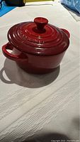 Side view of the cocotte showing two side handles and lid
