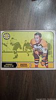 Front of the 1968 OPC Johnny Bucyk hockey card showing player image, team logo, and position details.