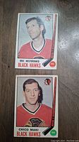 Front of Eric Nesterenko and Chico Maki hockey cards showing player image, name, Black Hawks logo and card number.