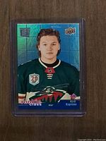 Clear photo of Kirill Kaprizov Rookie Class hockey card inside protective plastic sleeve. Front shows player portrait and logos.