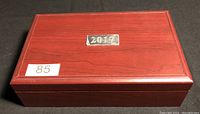 Closed wooden presentation box with a plaque marked '2017' and a sticker with number 85.
