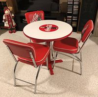 Full set showing white round tabletop with red trim and Coca-Cola logo, pedestal base and three matching chairs