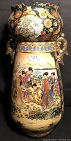 Full view of the Satsuma floor vase showcasing traditional Japanese figures in colorful kimonos, floral designs, and gold handles on cream and dark blue background.