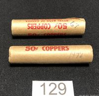 Two paper-wrapped rolls of Canadian pennies, one marked 1967, the other 1978.