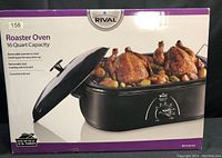 Front view of the Rival Roaster Oven packaging box showing the 16 Quart Capacity, removable enamel-on-steel roasting pan, removable steel roasting rack, and the oven lid with lid rest. The product image depicts roasted chickens and vegetables inside the oven.