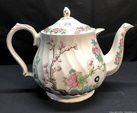 Full side profile of the large Sadler ceramic teapot decorated with multicolor floral design. The height is noted to be about 9 inches.