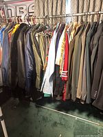 Photo showing a rack of men's jackets and shirts in various colors and fabrics.